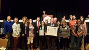 L:R Roosevelt County Detention Staff, Roosevelt County Manager Amber Hamilton, NMAC Executive Director Steve Kopelman, Adult Detention Administrator Larry Phillips, NMAC President Tyler Massey, Adult Detention Professional Standards Council Chair Manuel Romero and Detention Staff receiving their Certificate of Accreditation Award.